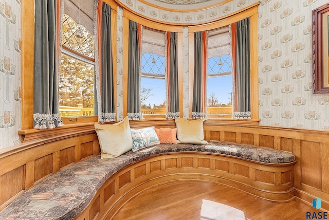 details with wallpapered walls and a wainscoted wall