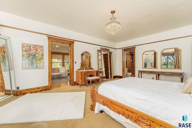 bedroom featuring a notable chandelier and light carpet