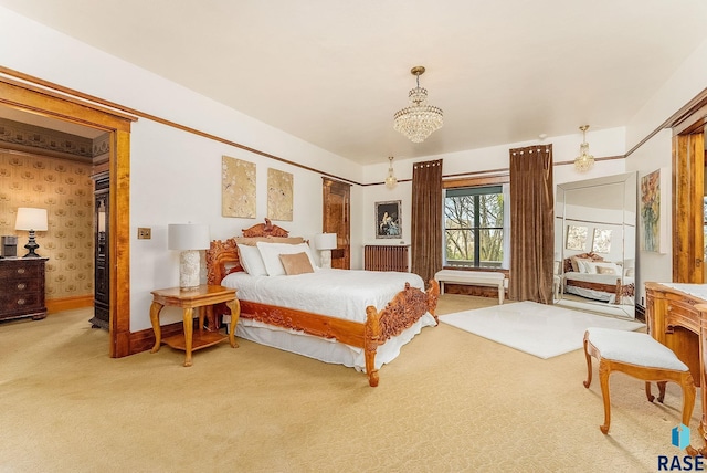 bedroom featuring light colored carpet, a chandelier, and baseboards