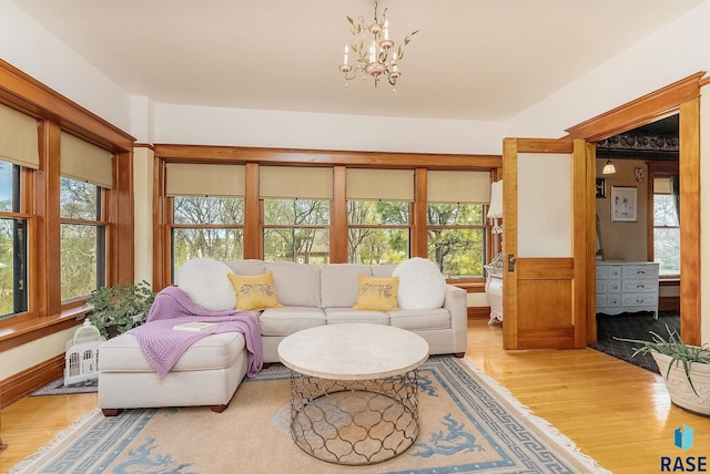living room with a chandelier and light wood-type flooring