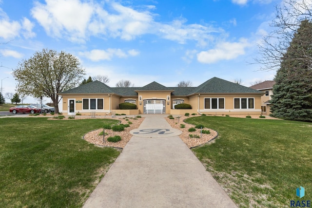 view of front of house featuring a front lawn, stucco siding, and concrete driveway