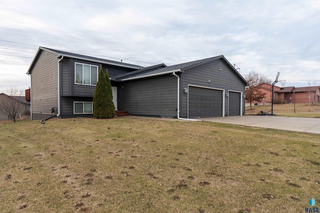 tri-level home featuring driveway, a front yard, and an attached garage