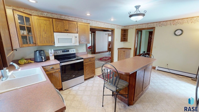 712 6th St, Brookings, SD 57006 - kitchen with light floors, white microwave, stainless steel range with electric cooktop, and a baseboard heating unit