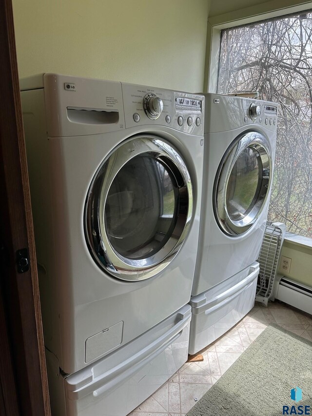 712 6th St, Brookings, SD 57006 - laundry room with tile patterned floors, a baseboard radiator, washer and clothes dryer, and laundry area