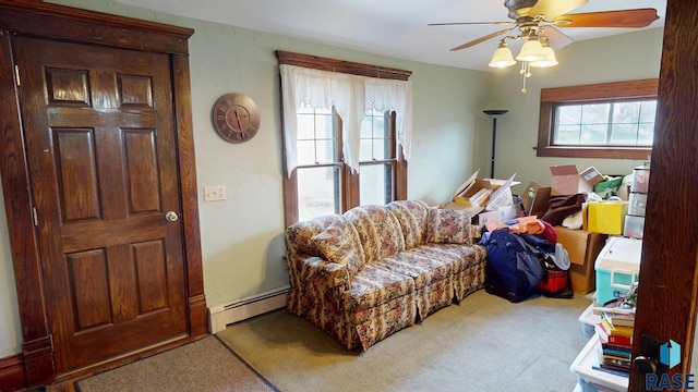 712 6th St, Brookings, SD 57006 - carpeted living room featuring a ceiling fan and a baseboard radiator