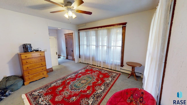 712 6th St, Brookings, SD 57006 - bedroom with a baseboard heating unit, a ceiling fan, and carpet floors