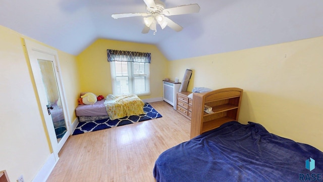 712 6th St, Brookings, SD 57006 - bedroom with a ceiling fan, wood finished floors, lofted ceiling, and baseboards