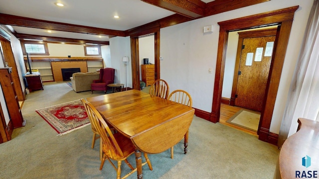 712 6th St, Brookings, SD 57006 - carpeted dining room with recessed lighting, baseboards, beam ceiling, and a fireplace