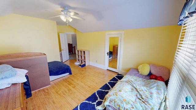 712 6th St, Brookings, SD 57006 - bedroom featuring wood finished floors, a ceiling fan, and vaulted ceiling