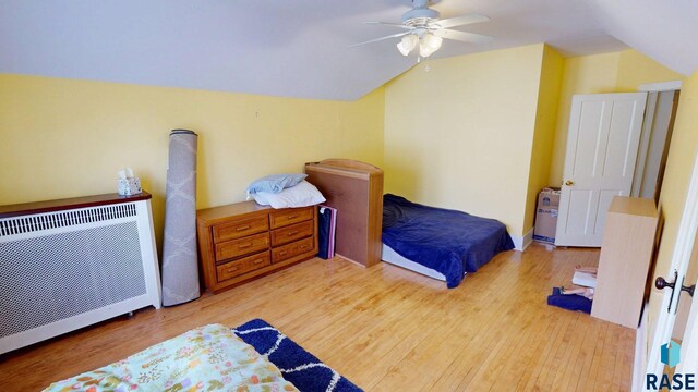 712 6th St, Brookings, SD 57006 - bedroom featuring lofted ceiling, wood finished floors, ceiling fan, and heating unit