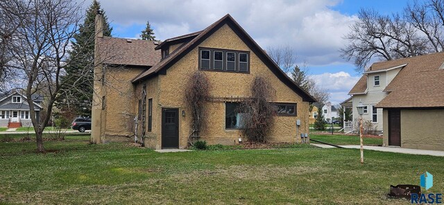 712 6th St, Brookings, SD 57006 - rear view of property featuring a yard