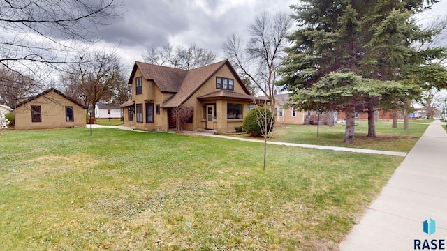 712 6th St, Brookings, SD 57006 - view of front of house with stucco siding and a front lawn
