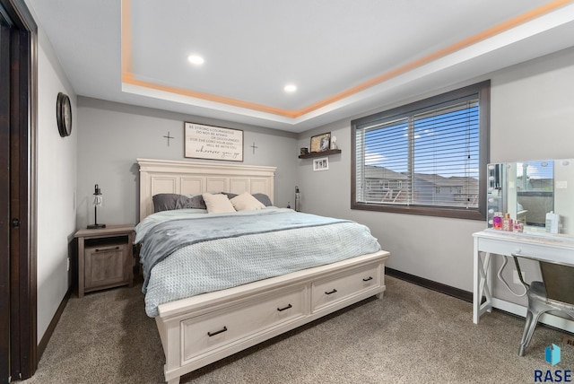 carpeted bedroom featuring baseboards, recessed lighting, and a raised ceiling