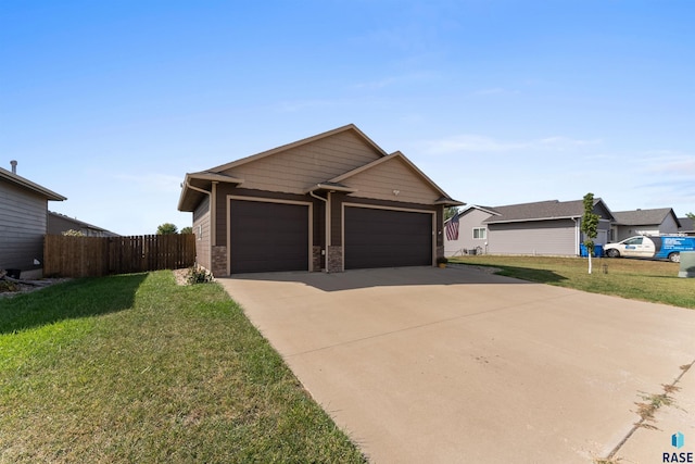 view of front facade with fence, a front yard, and stone siding