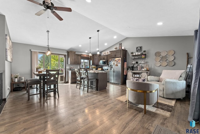 living room featuring wood finished floors, ceiling fan, recessed lighting, and vaulted ceiling