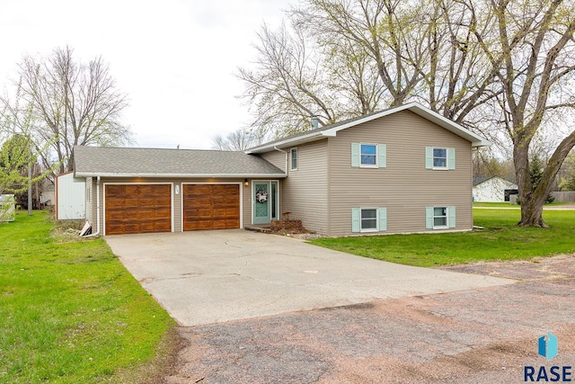 tri-level home featuring an attached garage, driveway, and a front yard