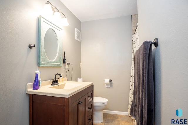 bathroom with vanity, toilet, and visible vents