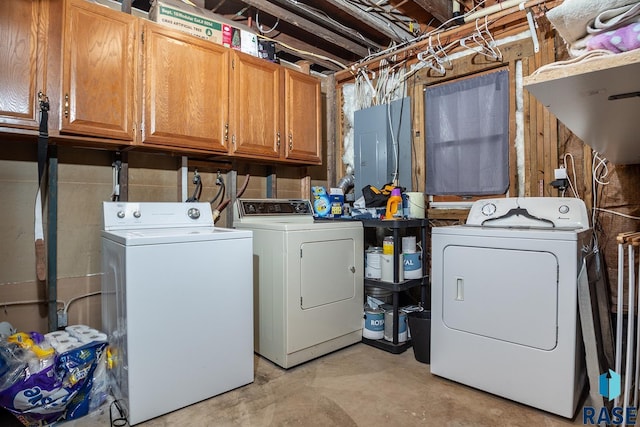 laundry area with cabinet space, separate washer and dryer, and electric panel