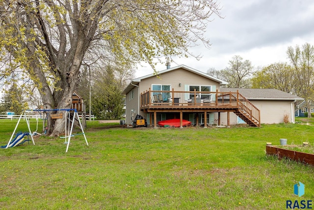 back of property featuring a lawn, stairway, a playground, and a deck