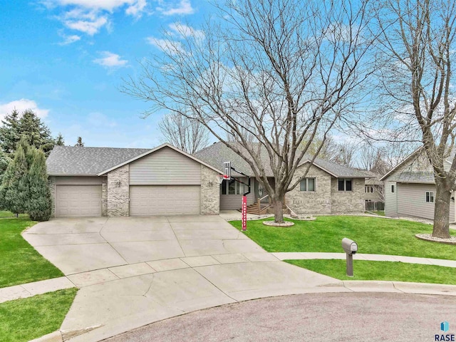 ranch-style home featuring a front yard, driveway, a garage, and brick siding