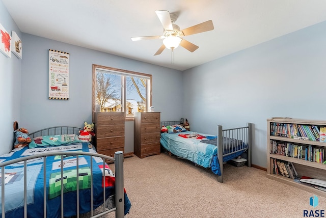 bedroom with ceiling fan, baseboards, and carpet floors