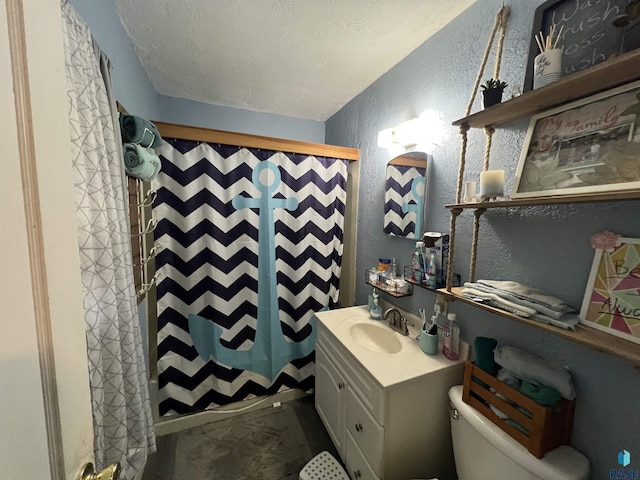 bathroom with vanity, curtained shower, toilet, a textured wall, and a textured ceiling