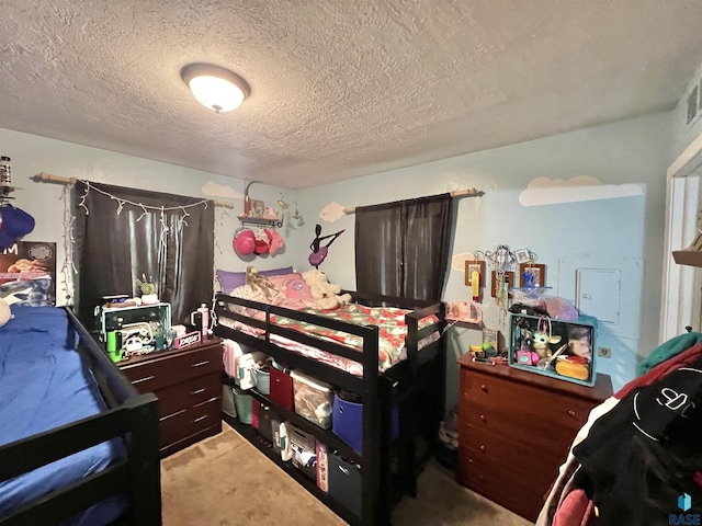bedroom featuring a textured ceiling and carpet floors
