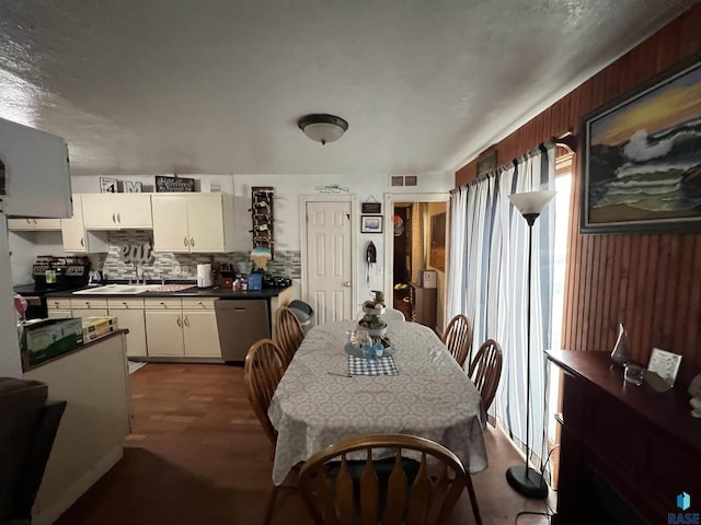 carpeted dining room with a sink
