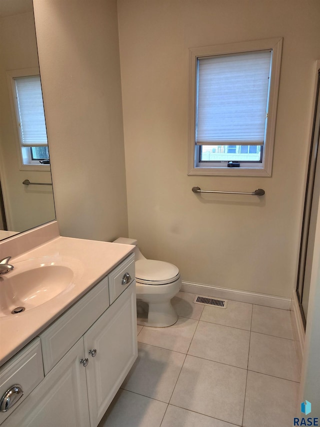 full bath featuring tile patterned floors, a wealth of natural light, vanity, and baseboards