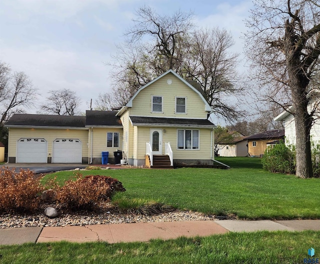view of front of property with a front lawn, a garage, and aphalt driveway