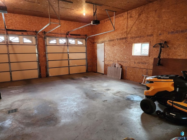 garage featuring visible vents and a garage door opener