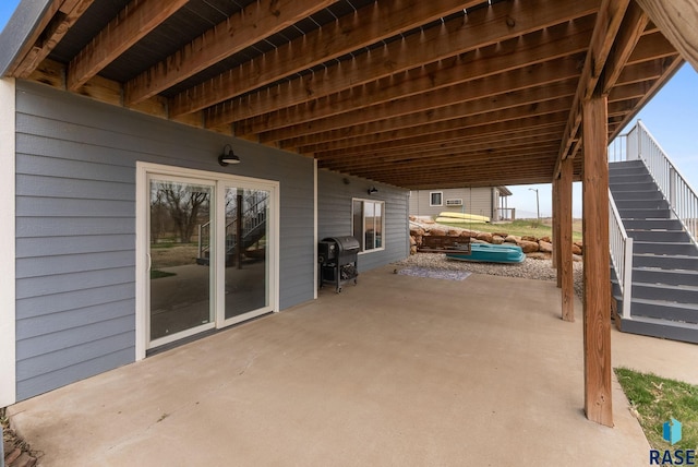 view of patio / terrace with area for grilling and stairway