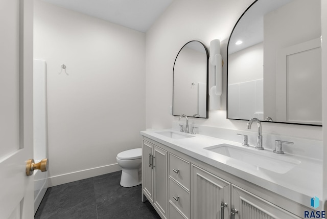8309 E Sheridan Cir, Sioux Falls, SD 57110 - bathroom with toilet, double vanity, a sink, and baseboards