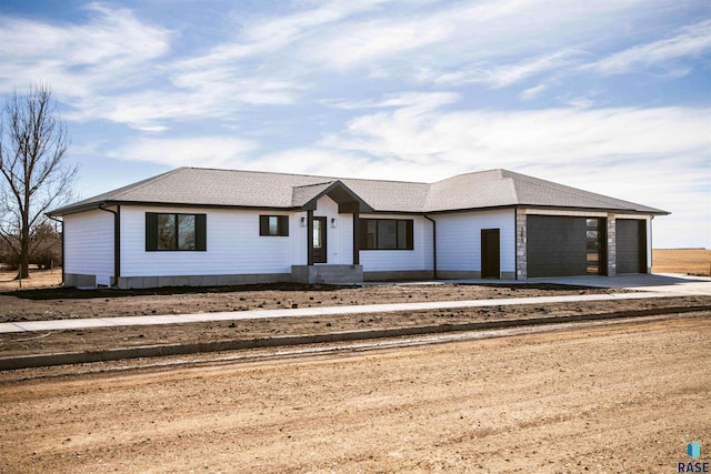 301 W 2nd St, Marion, SD 57043 - view of front facade with dirt driveway and a garage