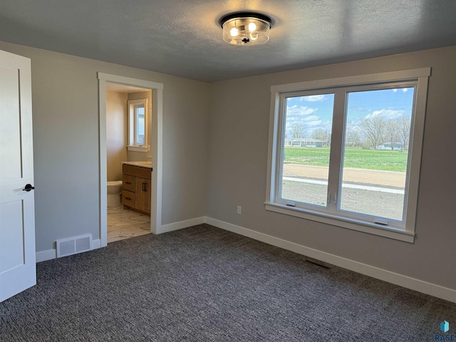 301 W 2nd St, Marion, SD 57043 - unfurnished room featuring a textured ceiling, visible vents, light colored carpet, and baseboards