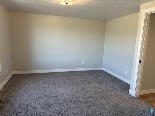 301 W 2nd St, Marion, SD 57043 - carpeted empty room featuring baseboards and a textured ceiling