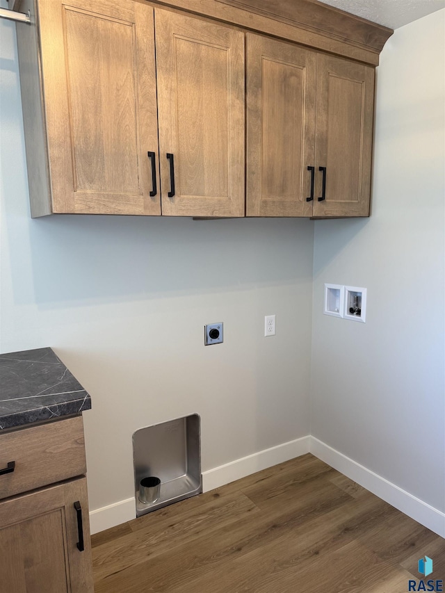 301 W 2nd St, Marion, SD 57043 - laundry room featuring baseboards, hookup for a washing machine, electric dryer hookup, cabinet space, and dark wood-style floors