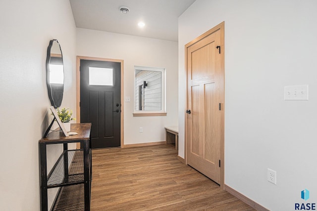 interior space featuring wood finished floors and baseboards