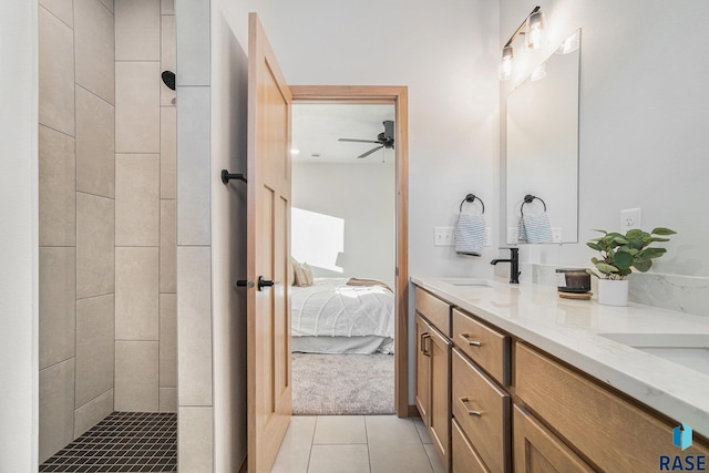 ensuite bathroom with connected bathroom, a sink, double vanity, ceiling fan, and tile patterned floors