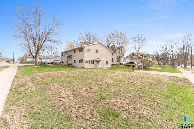 view of home's exterior featuring driveway and a lawn