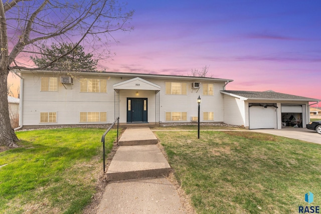 505 E 4th St, Canton, SD 57013 - split foyer home featuring a wall mounted AC, a yard, concrete driveway, and a garage