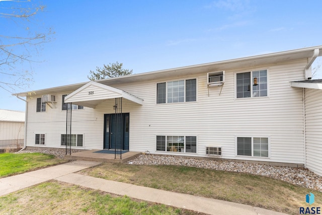 505 E 4th St, Canton, SD 57013 - raised ranch featuring a front yard and an AC wall unit