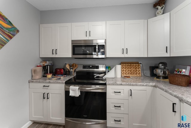110 N Kimball St, Canton, SD 57013 - kitchen with white cabinets, wood finished floors, and stainless steel appliances