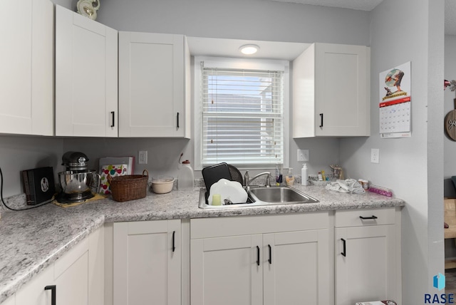 110 N Kimball St, Canton, SD 57013 - kitchen with a sink, white cabinetry, and light countertops
