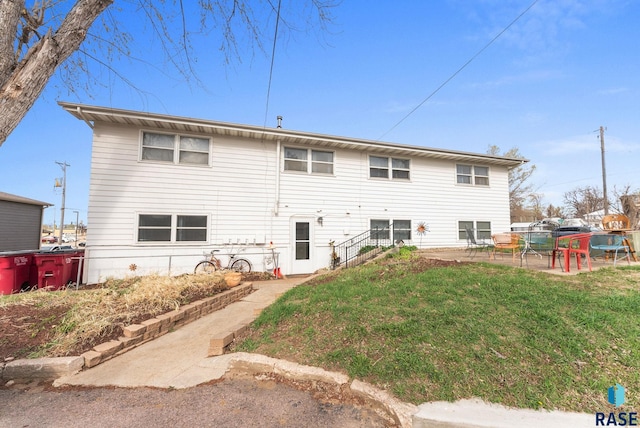 110 N Kimball St, Canton, SD 57013 - rear view of property featuring a yard and a patio area