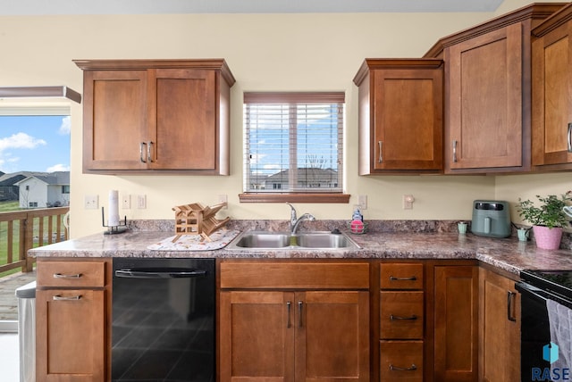 kitchen featuring black appliances, brown cabinets, and a sink