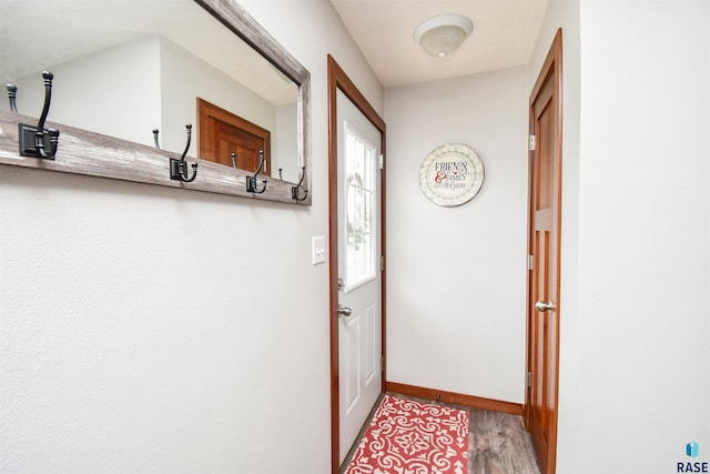 doorway featuring baseboards