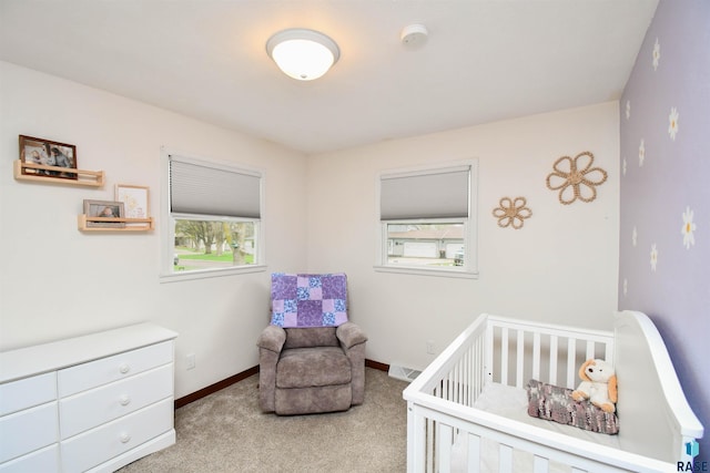bedroom featuring baseboards, carpet, and a nursery area