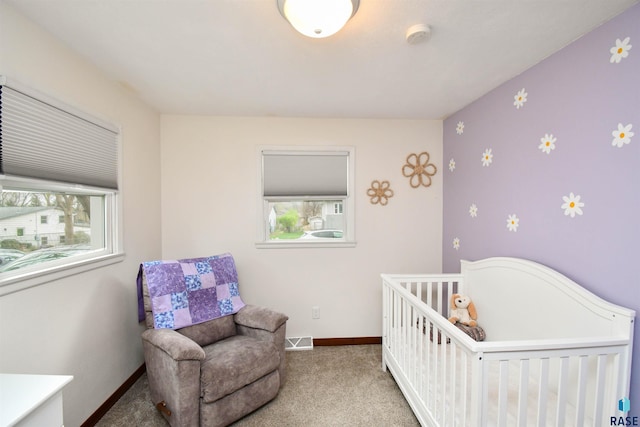 carpeted bedroom with visible vents, baseboards, and multiple windows