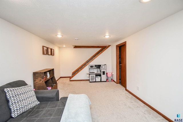 carpeted living area featuring recessed lighting and baseboards